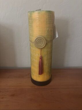 Yellow Decorative Pillar Candle with Red Tassel Accent tags